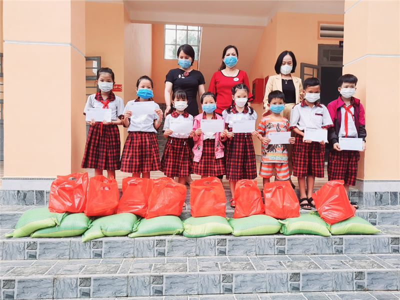 Bà Phan Thị Hồng Loan (áo đỏ) – Chủ tịch Hội CTĐ huyện Đạ Tẻh trao quà cho các em học sinh Trường Tiểu học Lê Lợi